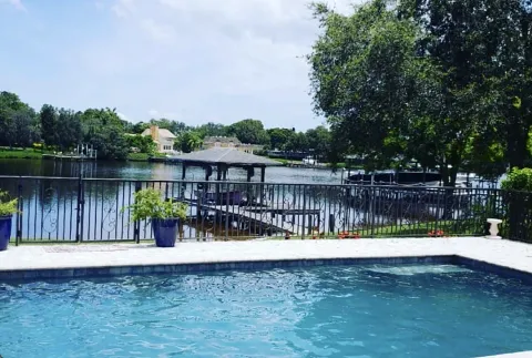 Pool behind a fence with a bay view